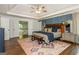 Bright main bedroom featuring tray ceilings, wood floors, and a view into the home at 210 Hunters Vw, Roswell, GA 30075