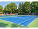Outdoor tennis courts for residents with blue and green surfaces, surrounded by fencing at 210 Hunters Vw, Roswell, GA 30075