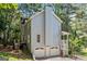 Back of the home featuring a two-car garage and wooded lot at 3 Maplelake Dr, Acworth, GA 30101