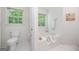 Bright bathroom featuring a separate bathtub, toilet, and natural light at 3 Maplelake Dr, Acworth, GA 30101