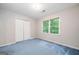 Cozy bedroom with a closet, a window, and neutral walls with blue carpeting at 3 Maplelake Dr, Acworth, GA 30101