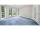 Bright bedroom features plush blue carpeting and light-filled windows with views of the surrounding greenery at 3 Maplelake Dr, Acworth, GA 30101