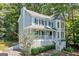 View of the charming two-story home with a welcoming front porch and lush landscaping at 3 Maplelake Dr, Acworth, GA 30101