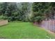 A large, well-maintained backyard features lush green grass and a wooden fence for privacy at 1911 Stancrest Nw Trce, Kennesaw, GA 30152