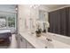 Bright bathroom featuring a large mirror and white quartz countertops at 1911 Stancrest Nw Trce, Kennesaw, GA 30152