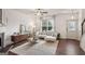 Bright living room featuring a modern fireplace, plush sofa, and stylish decor at 1911 Stancrest Nw Trce, Kennesaw, GA 30152