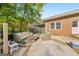 Relaxing outdoor space with comfortable seating, mature shade trees, and view of the brick house at 222 Bishop Ne Dr, Marietta, GA 30060