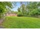 Sprawling backyard featuring an expansive lawn, mature trees, and wooden fence perimeter at 222 Bishop Ne Dr, Marietta, GA 30060