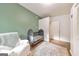 Bright Bedroom with olive green accent wall, white chair, baby crib and large closet at 222 Bishop Ne Dr, Marietta, GA 30060