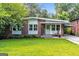 Charming brick home featuring a well-maintained lawn and inviting front porch at 222 Bishop Ne Dr, Marietta, GA 30060