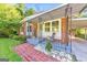 Inviting front porch with brick detail, seating area, and convenient covered parking at 222 Bishop Ne Dr, Marietta, GA 30060
