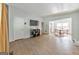 Inviting living room featuring hardwood floors, TV, with adjoining dining room at 222 Bishop Ne Dr, Marietta, GA 30060