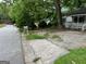Street view of a property with a classic mailbox, paved parking area, and partial house view at 766 Warren Dr, Riverdale, GA 30296