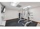 Home gym featuring work out machine, black rubber flooring, and drop ceiling at 2110 Waterloo Cir, Lawrenceville, GA 30043