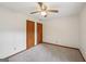 Carpeted bedroom featuring a ceiling fan, and two wood-panel closets for ample storage space at 2110 Waterloo Cir, Lawrenceville, GA 30043