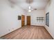 Bright bedroom with neutral walls and hardwood floors, featuring a ceiling fan at 2110 Waterloo Cir, Lawrenceville, GA 30043