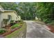 Long driveway leading to a charming two-story home surrounded by trees and greenery at 2110 Waterloo Cir, Lawrenceville, GA 30043