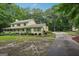 Side view of two-story home with charming landscaping, and a long concrete driveway at 2110 Waterloo Cir, Lawrenceville, GA 30043