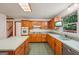 Charming kitchen features wood cabinets, an oven, and a window overlooking greenery at 2110 Waterloo Cir, Lawrenceville, GA 30043
