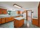 Well-lit kitchen featuring an island, tiled floor, and wood cabinetry at 2110 Waterloo Cir, Lawrenceville, GA 30043