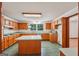 Spacious kitchen features wood cabinetry, tile flooring, and a center island at 2110 Waterloo Cir, Lawrenceville, GA 30043