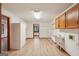 Functional laundry room with hardwood floors, cabinets, a utility sink, and metal shelving at 2110 Waterloo Cir, Lawrenceville, GA 30043