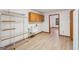 Organized laundry room featuring a utility sink, metal shelving, cabinets, and hardwood floors at 2110 Waterloo Cir, Lawrenceville, GA 30043