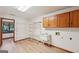 Bright laundry room with hardwood floors, washer hook-ups, cabinets, and wire shelving at 2110 Waterloo Cir, Lawrenceville, GA 30043