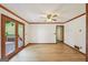 Bright room featuring wood-look floors, ceiling fan, and access to a deck at 2110 Waterloo Cir, Lawrenceville, GA 30043