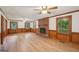 Cozy living room with wood paneling, a brick fireplace, and wood-look flooring at 2110 Waterloo Cir, Lawrenceville, GA 30043