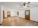 Bright living room with hardwood floors, a ceiling fan, and a wood door for access to the outside at 2110 Waterloo Cir, Lawrenceville, GA 30043