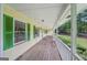 Inviting covered porch with wood flooring and bright green shutters on windows at 2110 Waterloo Cir, Lawrenceville, GA 30043