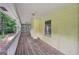 Long screened-in porch with wood flooring and view of yard at 2110 Waterloo Cir, Lawrenceville, GA 30043