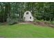 Charming shed nestled amongst mature trees, perfect for extra storage or a workshop at 2110 Waterloo Cir, Lawrenceville, GA 30043