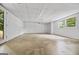 Unfinished basement with concrete floor, white walls, and a window at 3332 St John Dr, East Point, GA 30344