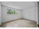 Unfinished basement with concrete floor, a window for natural light, and door leading to a hall at 3332 St John Dr, East Point, GA 30344