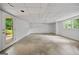 Unfinished basement with concrete flooring, a door to the backyard, and a bright window at 3332 St John Dr, East Point, GA 30344