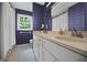 Well-lit bathroom with double sinks, framed mirror and shower/tub combination at 3332 St John Dr, East Point, GA 30344