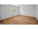 Bright bedroom features beautiful wood floors, a ceiling fan, and a window for ample natural light at 3332 St John Dr, East Point, GA 30344