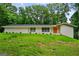 Charming one-story home with a brick facade, green lawn, and colorful front door at 3332 St John Dr, East Point, GA 30344