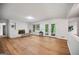Open living room area featuring a brick fireplace, hardwood floors, and french doors at 3332 St John Dr, East Point, GA 30344