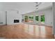 Spacious living room with brick fireplace, hardwood flooring and large windows overlooking the backyard at 3332 St John Dr, East Point, GA 30344