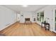 Cozy living room featuring a brick fireplace, hardwood floors, and plenty of light at 3332 St John Dr, East Point, GA 30344