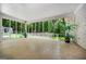 Large sunroom with floor-to-ceiling windows overlooking the lush backyard at 3332 St John Dr, East Point, GA 30344