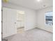 Bright bedroom featuring a window, with attached bath at 3614 Squires Park Ln, Loganville, GA 30052
