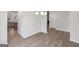 Bright dining area featuring wood-look floors and chandelier lighting adjacent to a kitchen at 3614 Squires Park Ln, Loganville, GA 30052