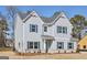 Charming two-story home with light-blue siding, dark shutters, brick foundation, and well-manicured landscaping at 3614 Squires Park Ln, Loganville, GA 30052