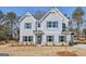 Charming two-story home with light-blue siding, dark shutters, brick foundation, and well-manicured landscaping at 3614 Squires Park Ln, Loganville, GA 30052
