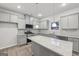 Kitchen with granite countertops, stainless appliances, kitchen island, and hanging pendant lights at 3614 Squires Park Ln, Loganville, GA 30052