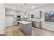 Bright kitchen features stainless appliances, granite countertops, an island and ample cabinet space at 3614 Squires Park Ln, Loganville, GA 30052